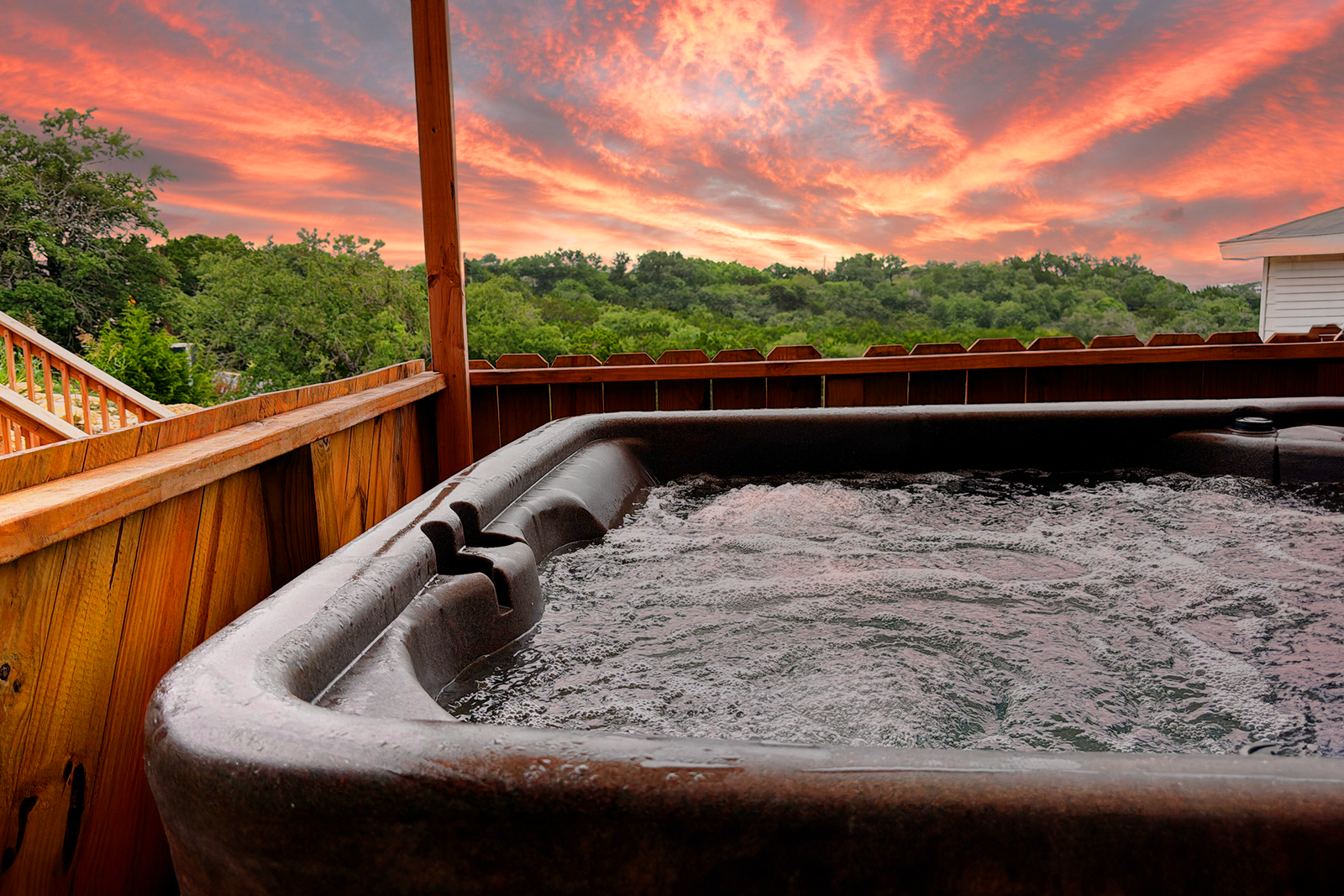 Private hot tub with a stunning sunset view, offering a relaxing experience near Canyon Lake hotels