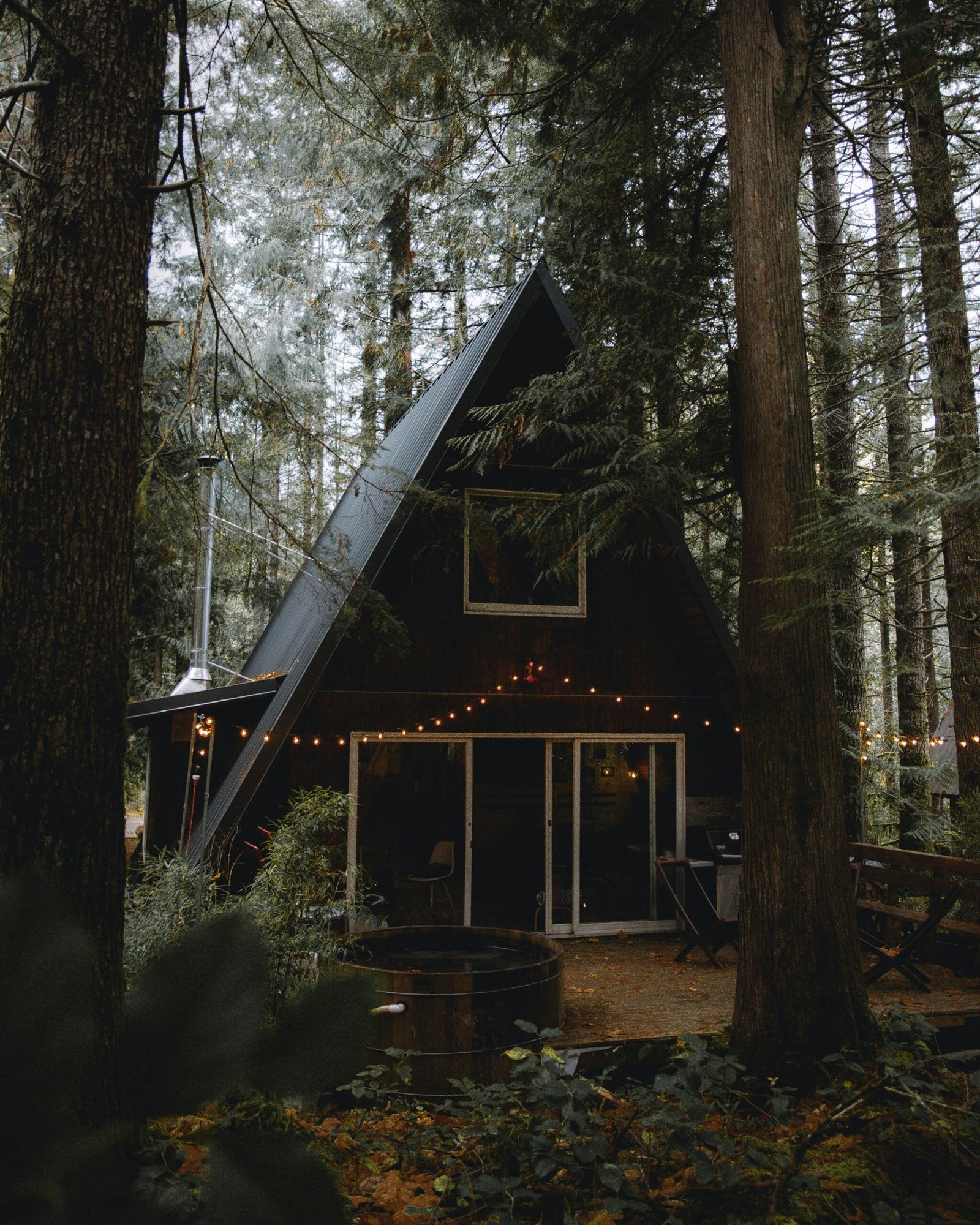 A cozy A-frame cabin surrounded by trees, ideal for intimate gatherings and perfect for exploring the best Canyon Lake cabins.