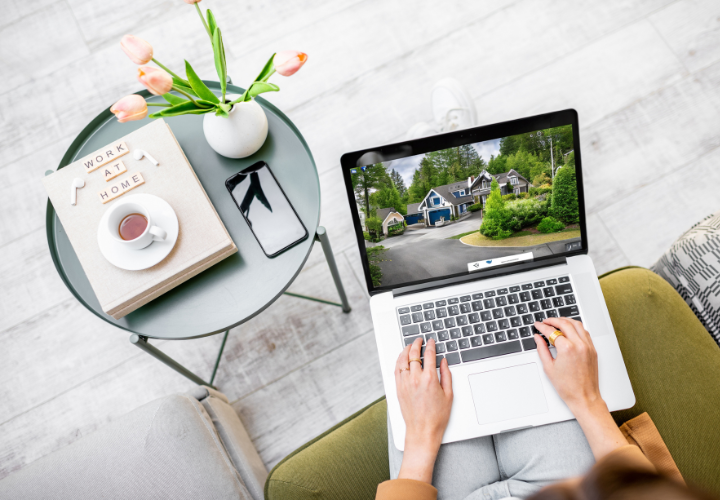 A person researching wedding venues online, showcasing a picturesque property surrounded by greenery.